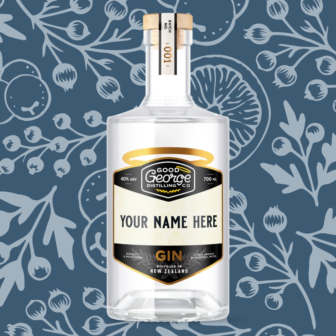 Clear gin bottle with a customizable label on a blue botanical background