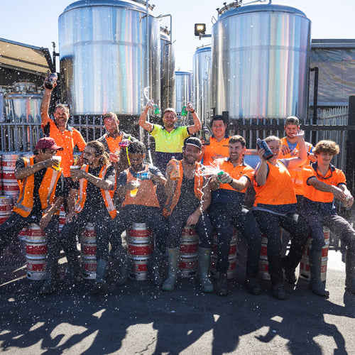 Good George Brewers having fun with fizzed up beers sitting on kegs