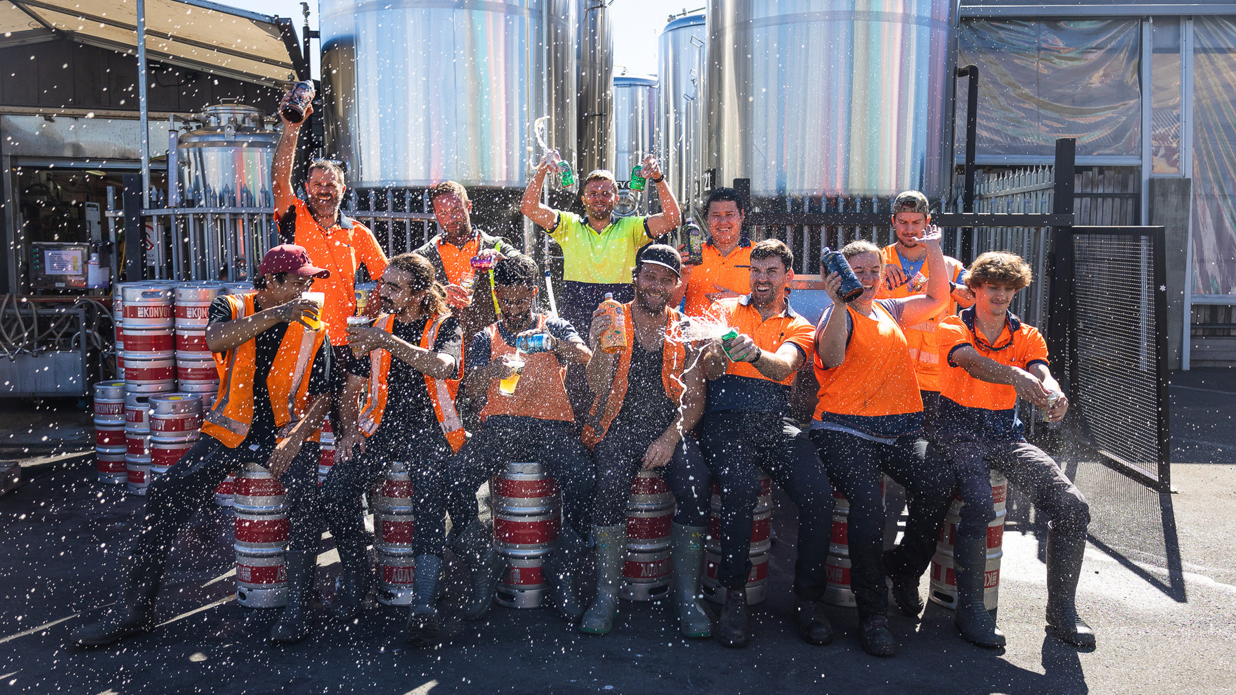 Good George Brewers having fun with fizzed up beers sitting on kegs