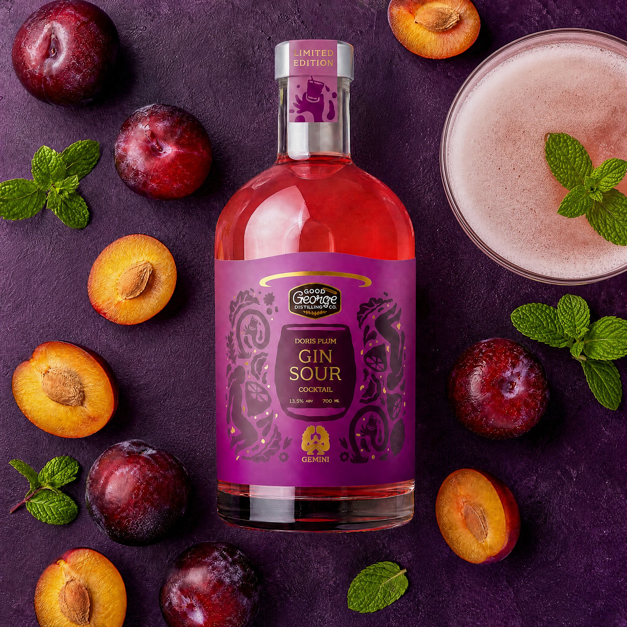 Bottle of Sour George Plum Gin Sour with plums and a cocktail on a dark background