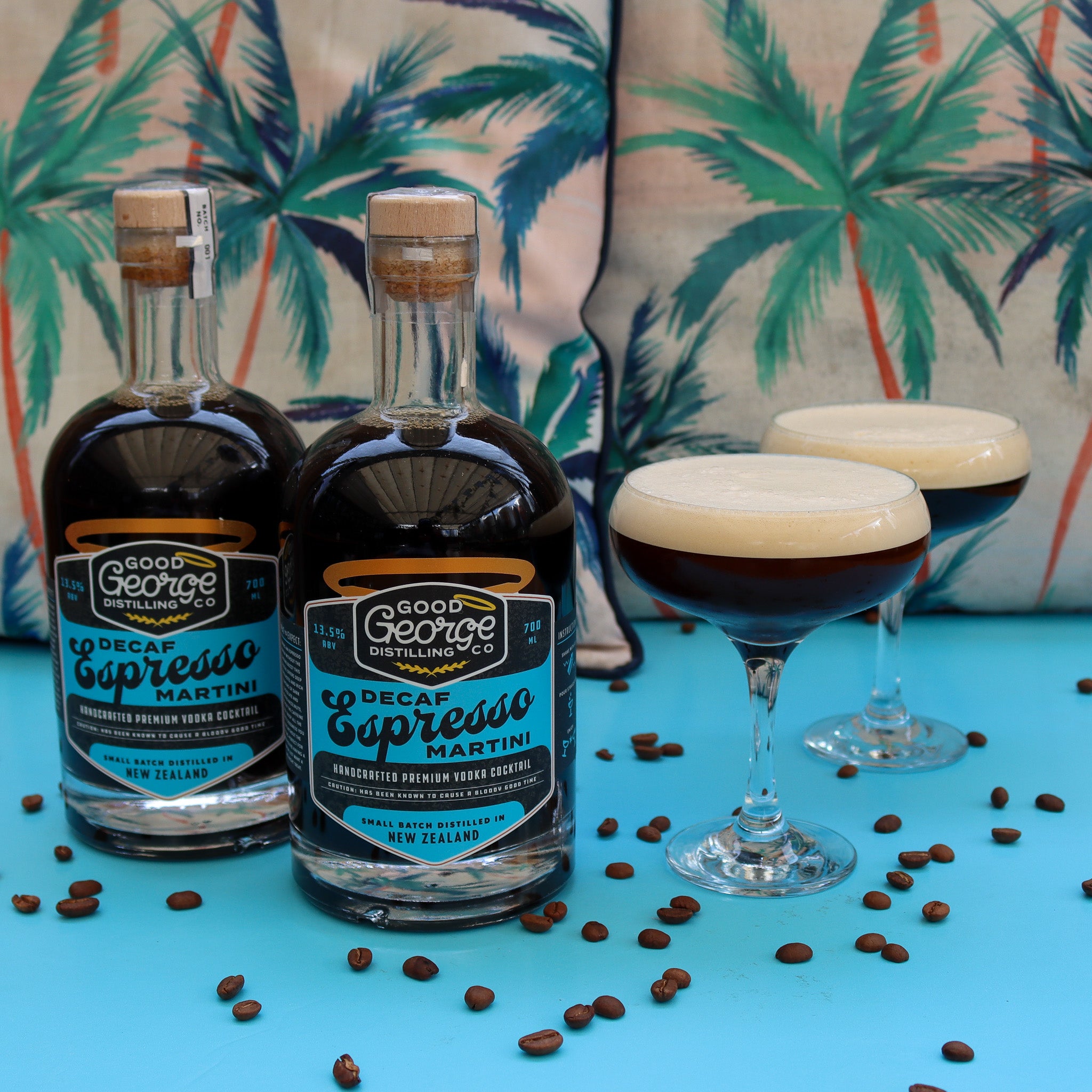 2 bottles of Decaf Espresso Martini and 2 Decaf Espresso Martini's next to it showcased with coffee beans around it