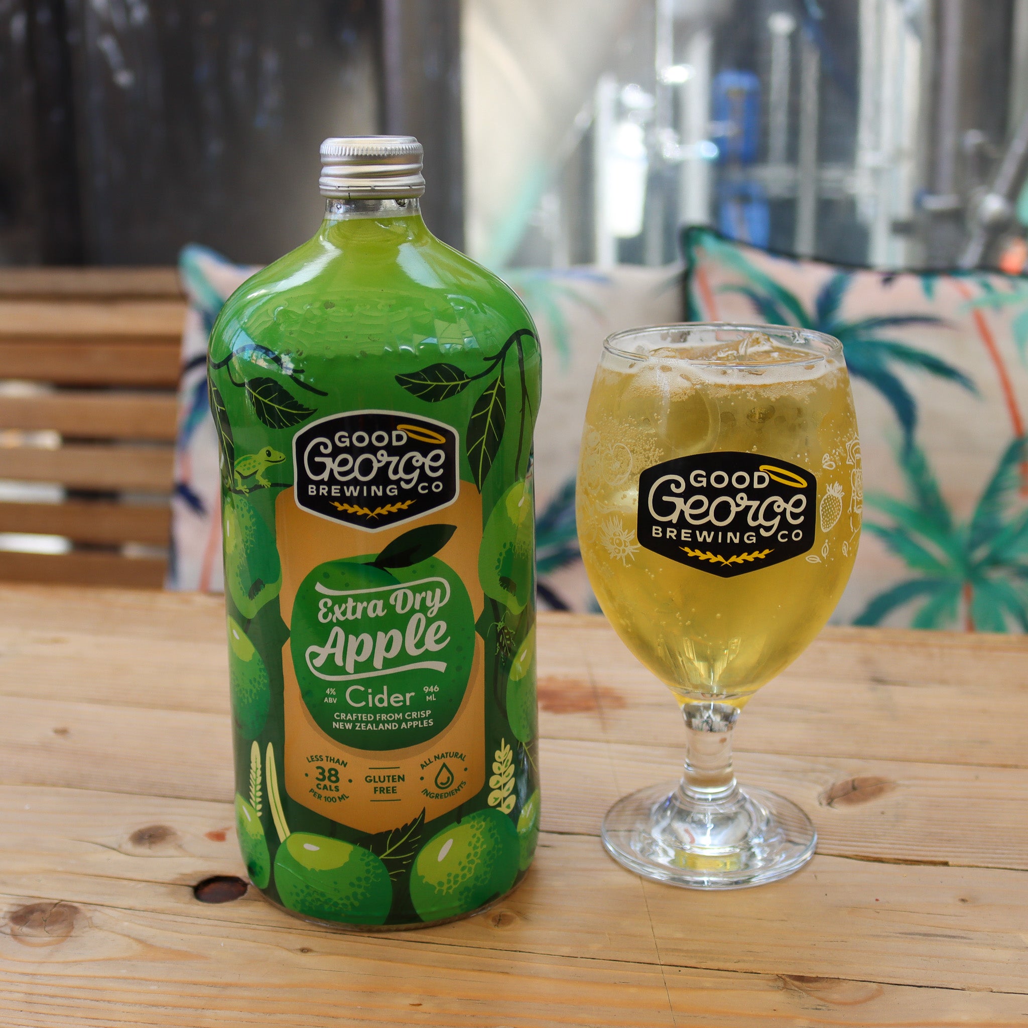 A bottle of Extra Dry Apple Cider with cider glass next to it.
