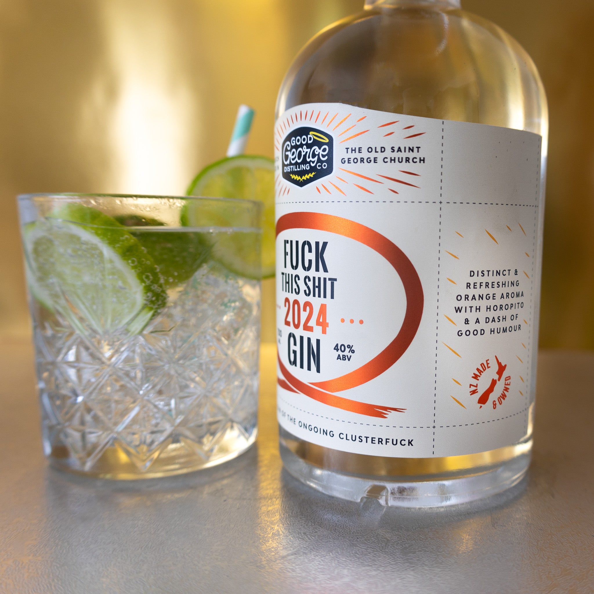 The image features a clear glass bottle of "Fuck This Shit 2024 Gin" with a bold, red label that reads "FUCK THIS SHIT 2024 GIN" in large, capital letters.