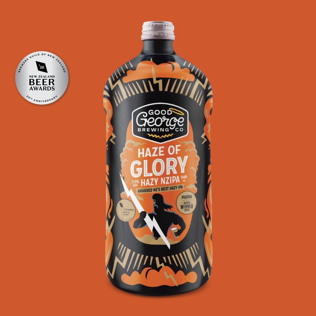 A bottle of Good George Brewing Co. 'Haze of Glory' beer centered on a solid orange background, with a silver award seal in the upper left.
