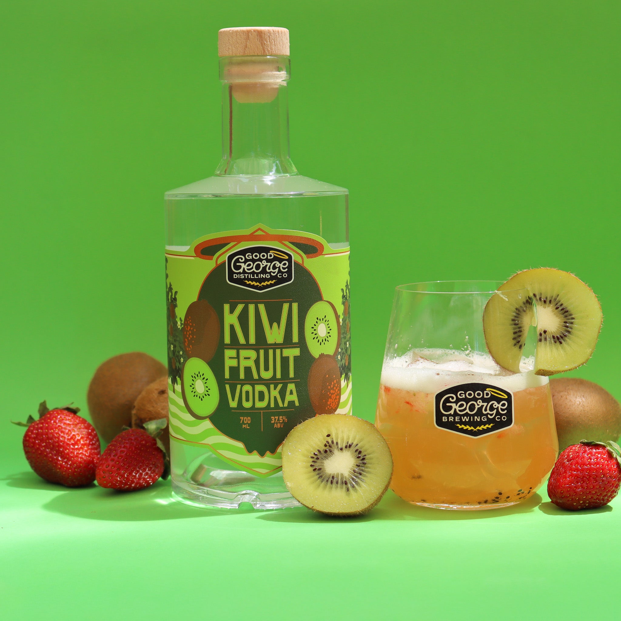 Bottle of kiwi fruit vodka with a kiwifruit vodka drink next to it with kiwifruit slices and strawberry