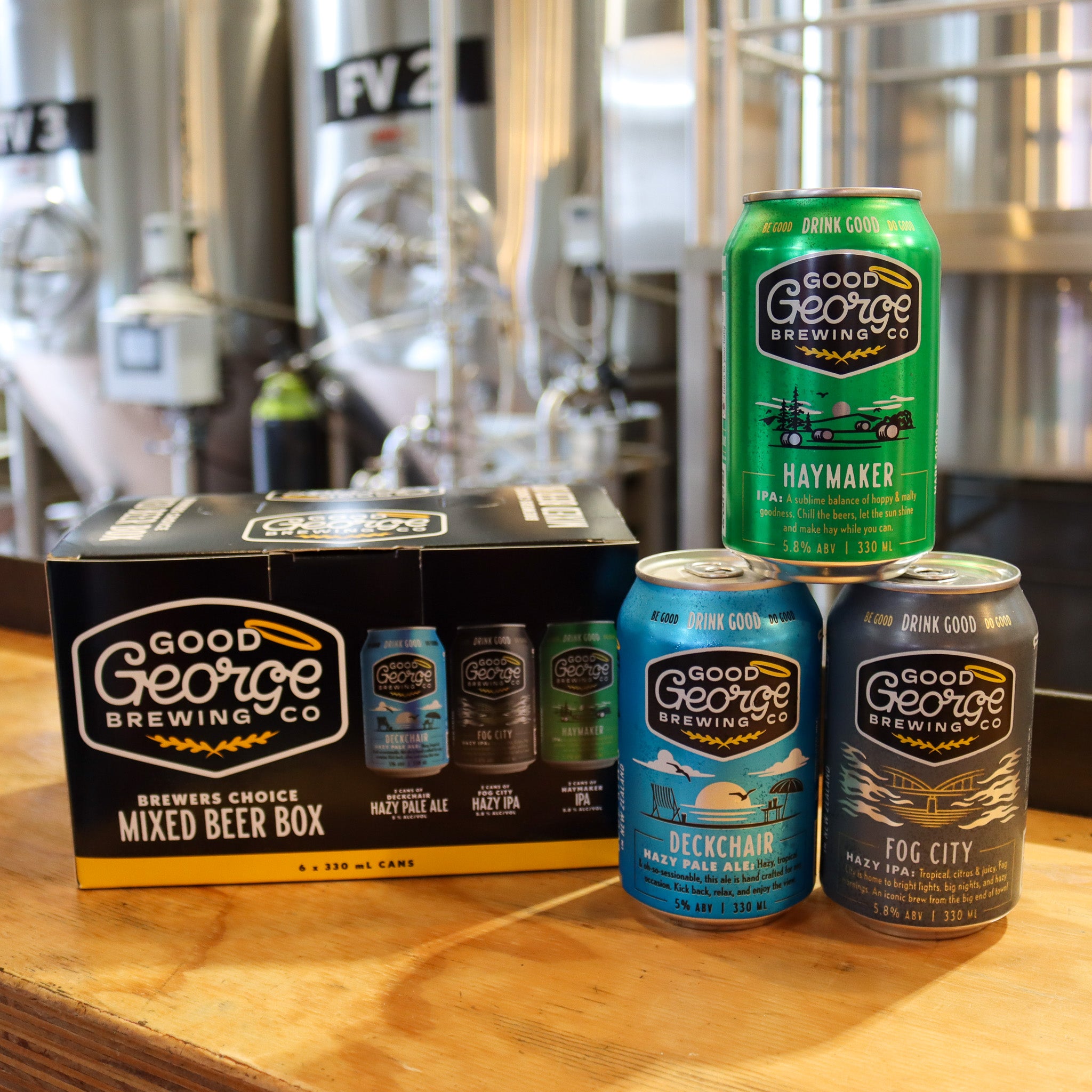 A 'Brewer's Choice Mixed Beer Box' from Good George Brewing with three types of beer cans displayed in front: Deckchair Hazy Pale Ale, Fog City Hazy IPA, and Haymaker IPA.