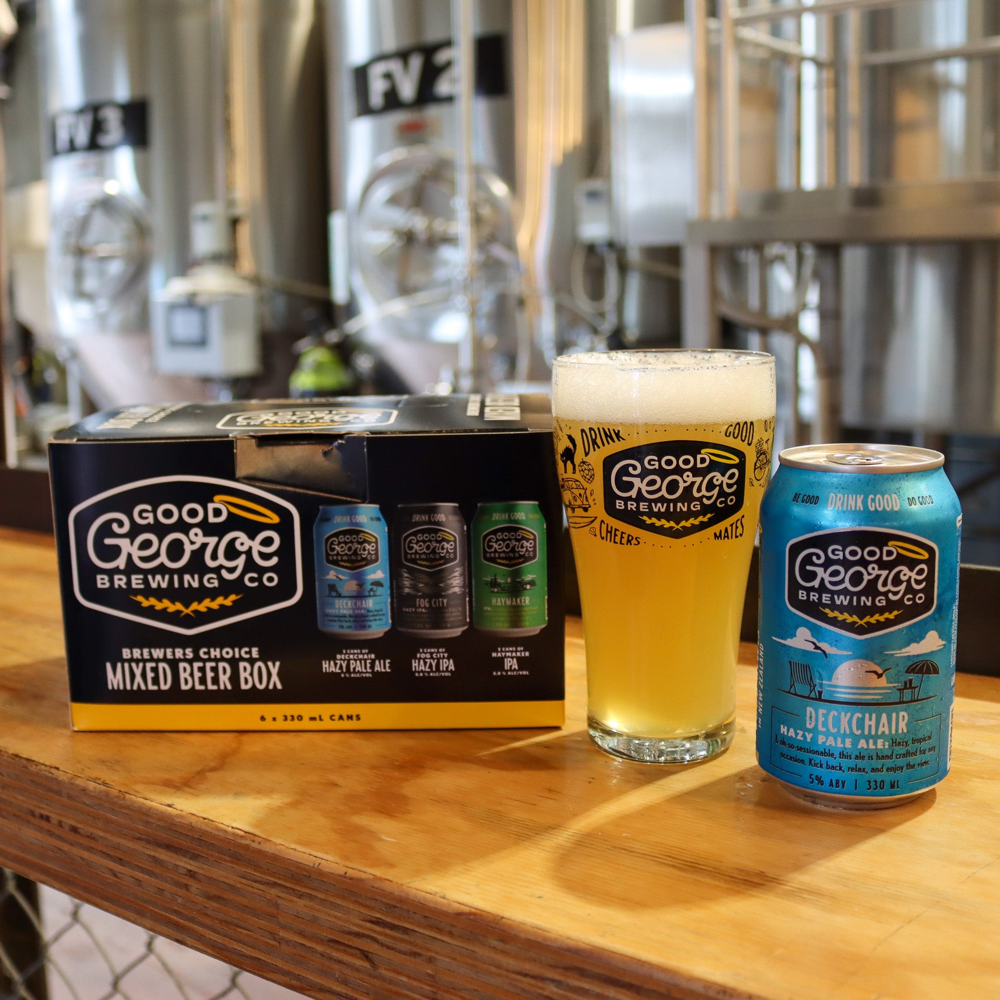 A 'Brewer's Choice Mixed Beer Box' from Good George Brewing with three types of beer cans displayed in front: Deckchair Hazy Pale Ale, Fog City Hazy IPA, and Haymaker IPA.