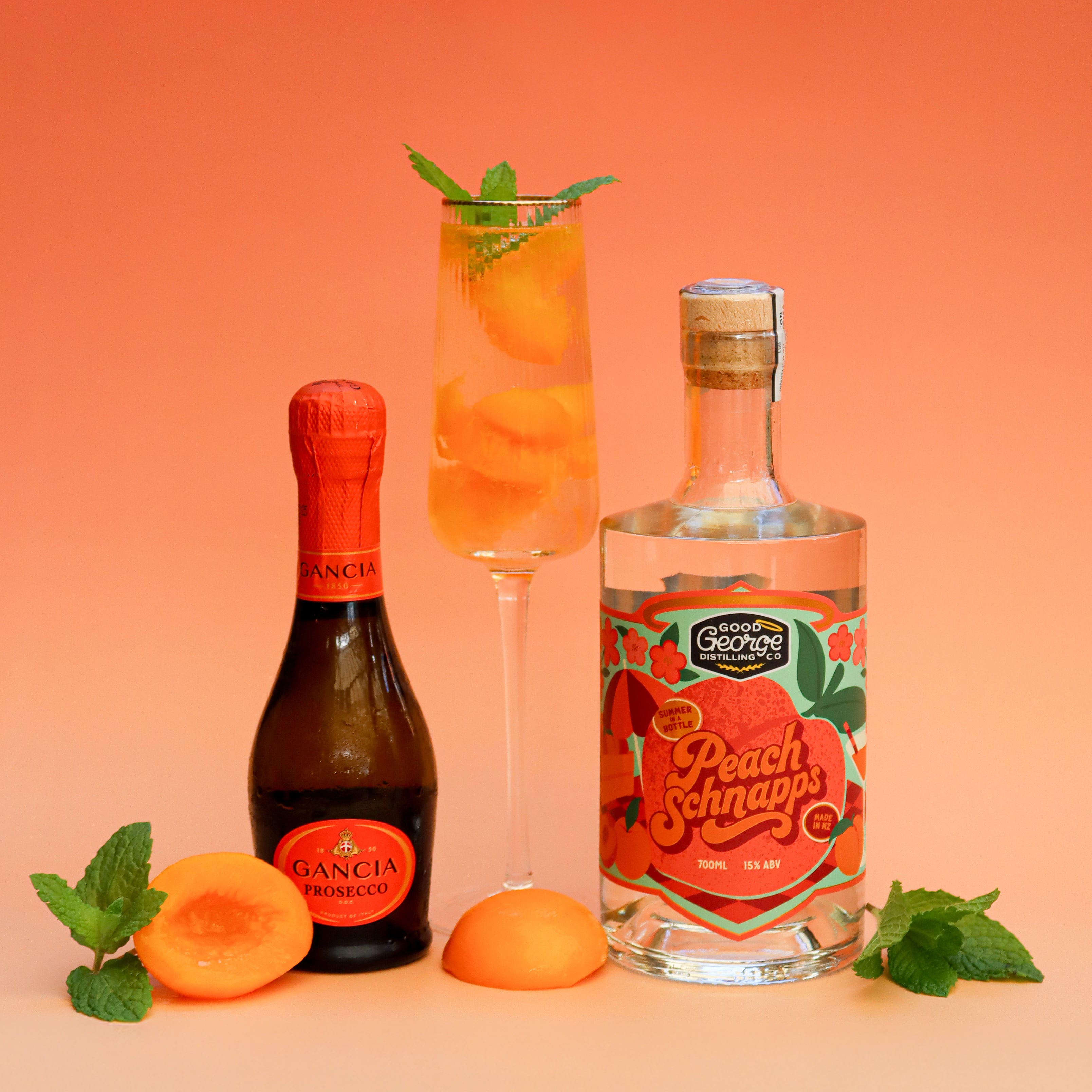 Bottle of Peach Schnapps with a glass of peach schnapps cocktail on an orange background