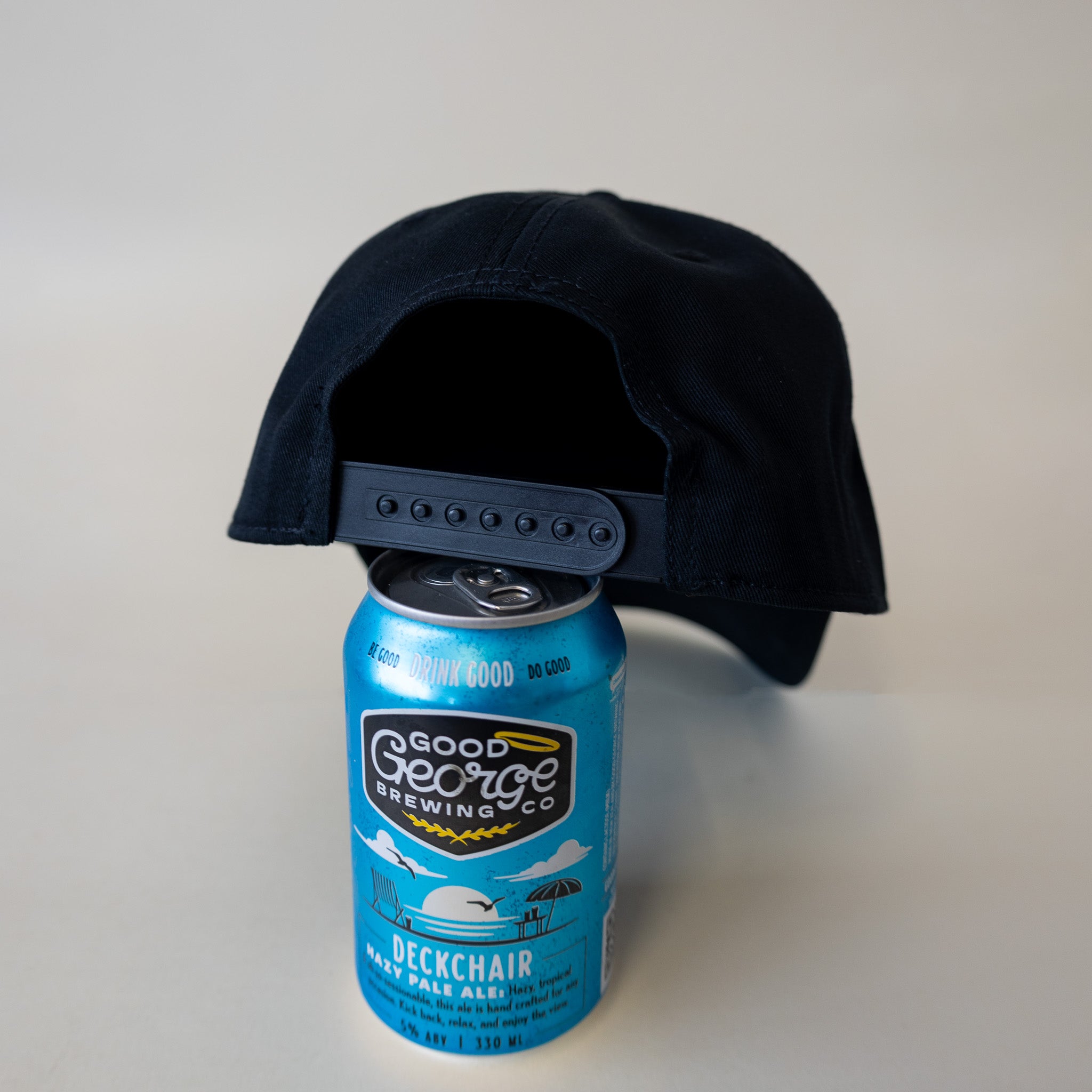A black George snapback cap with a curved peak and an embroidered logo on the front.