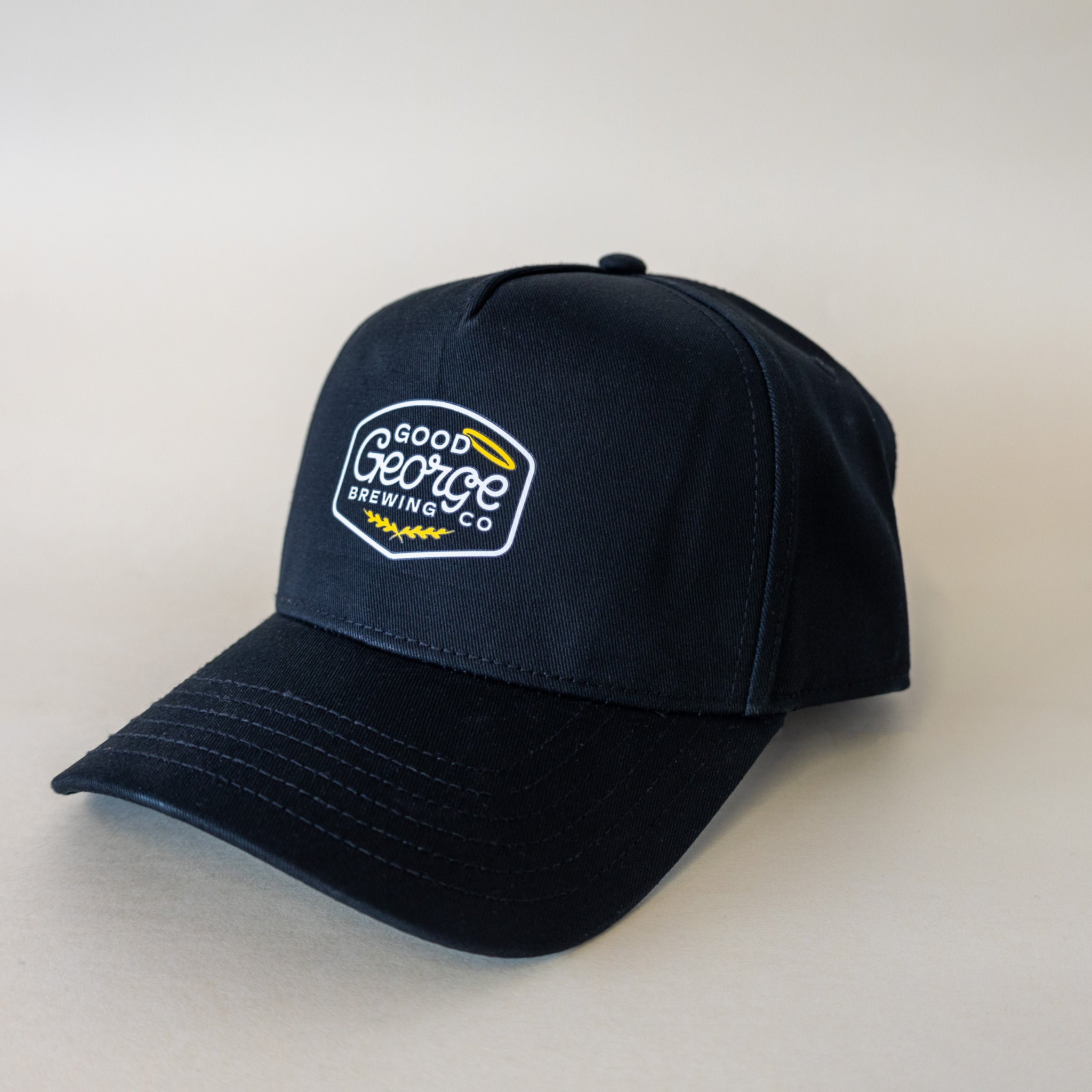 A black George snapback cap with a curved peak and an embroidered logo on the front.