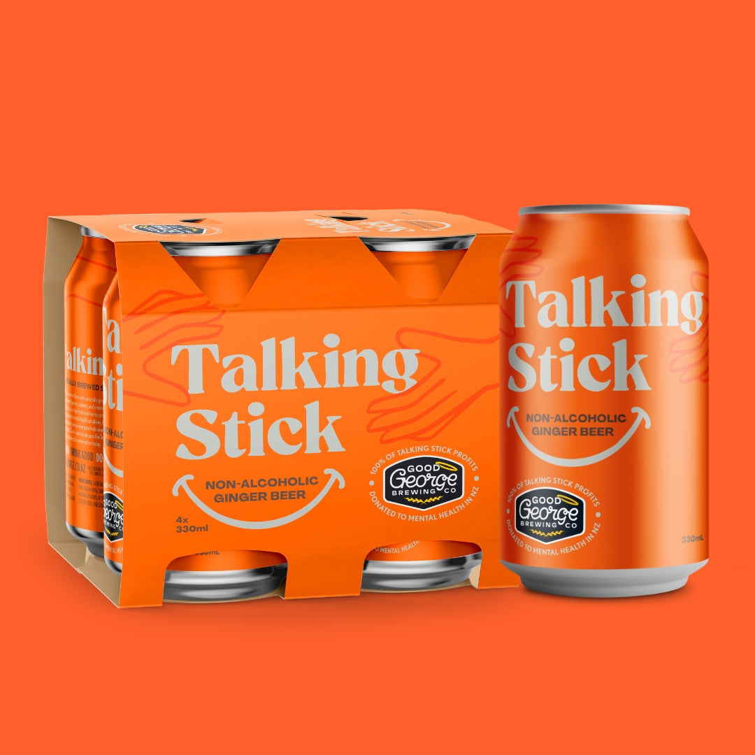 An orange six-pack cardboard case and a single matching can of Talking Stick Non-Alcoholic Ginger Beer on a solid orange background.
