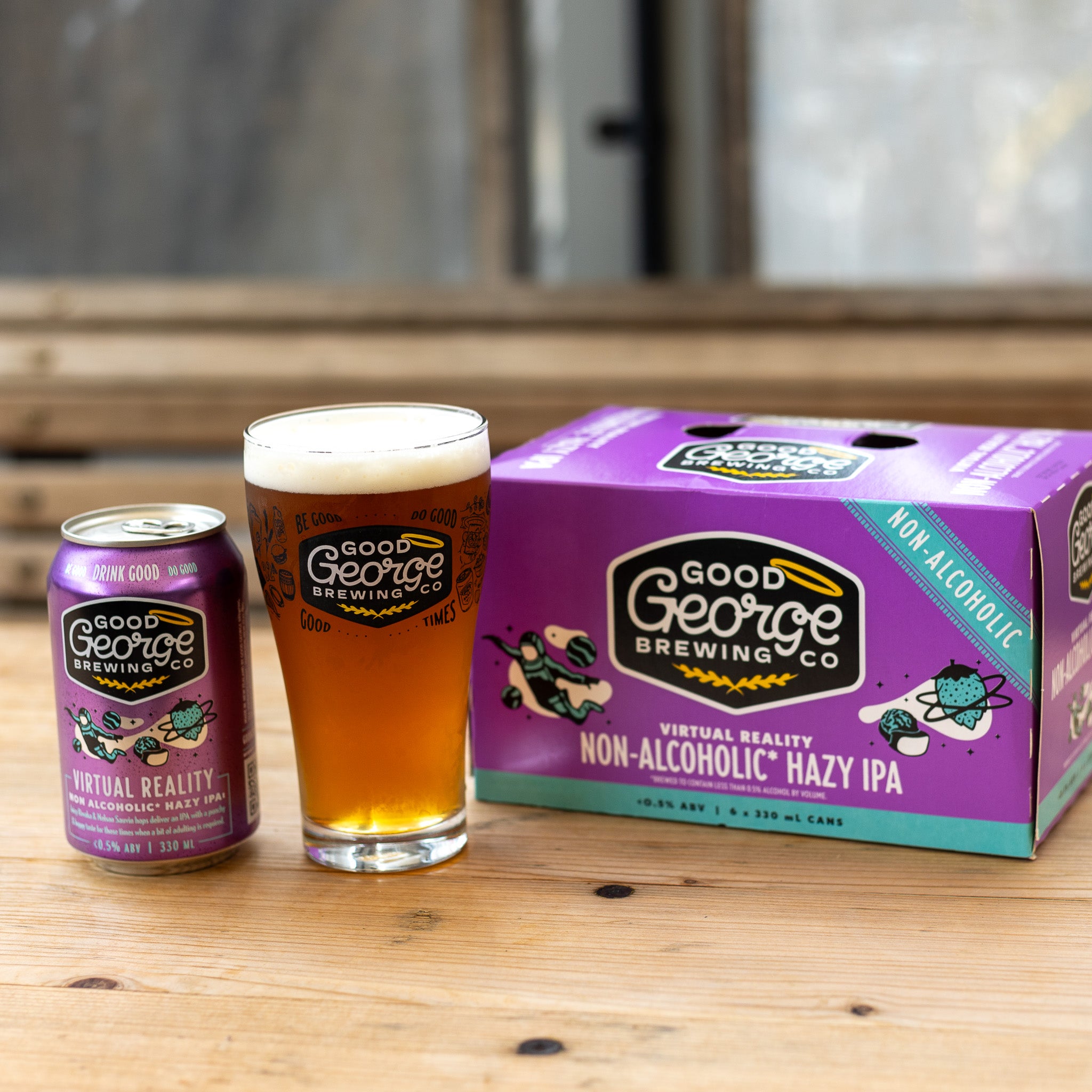 A can of Good George Virtual Reality Non-Alcoholic Hazy IPA with a beer glass and six pack