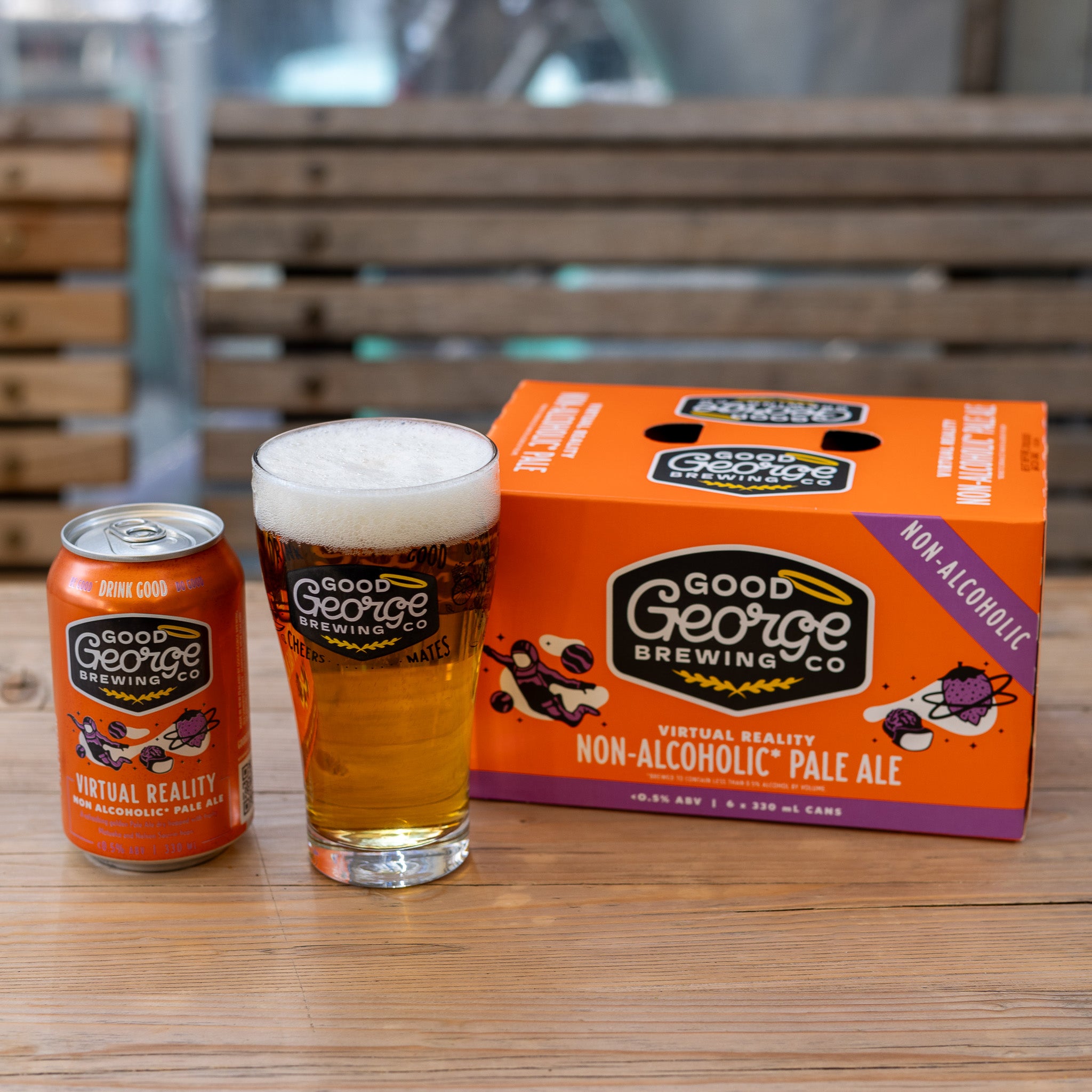A can of Virtual Reality Non-Alcoholic Pale Ale by Good George Brewing Co. a beer glass and a six pack next to it.