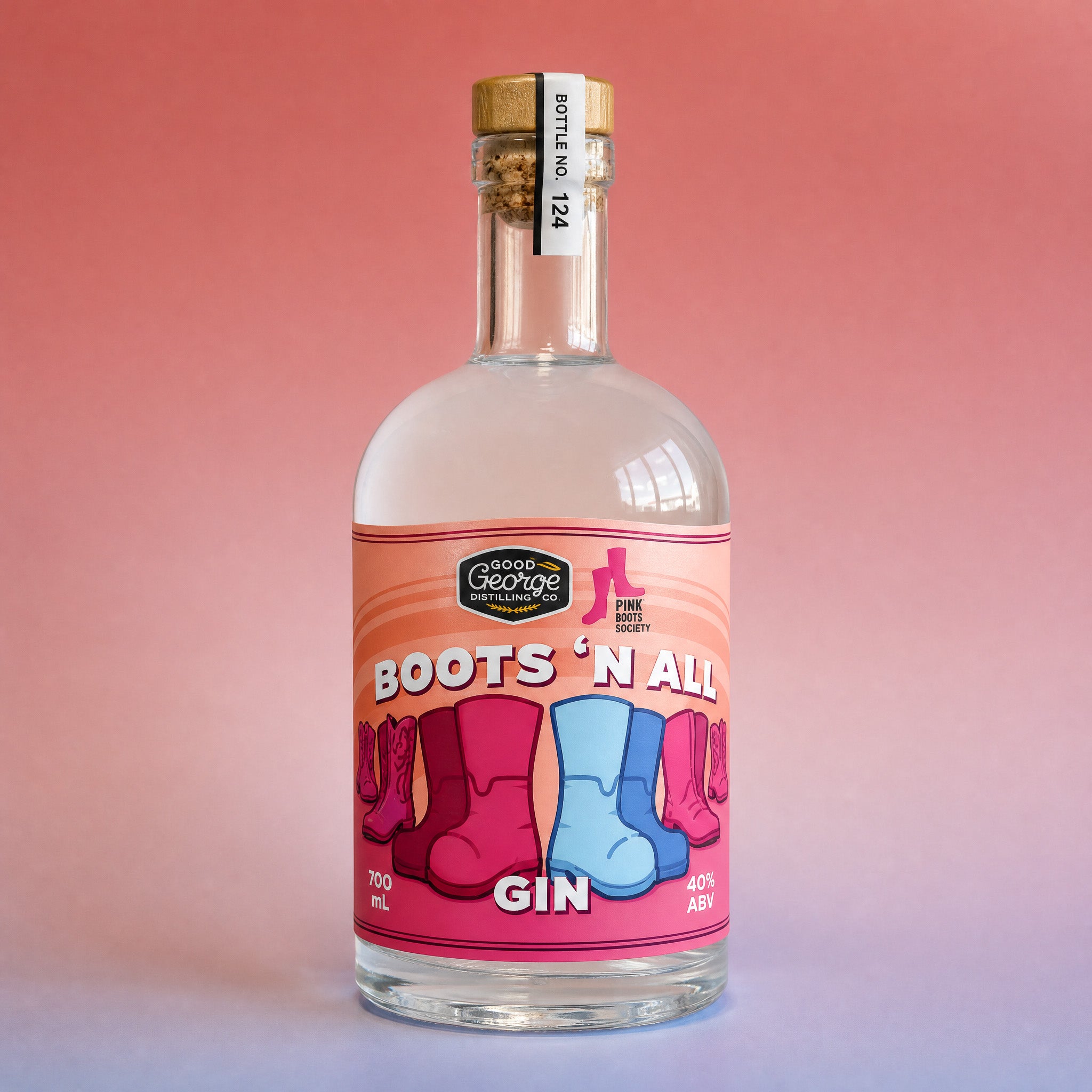 A bottle of Goose Drinking Spirits 'Boots 'N All' Gin, featuring a pink label with cowboy boots illustrations, set against a pink gradient background.