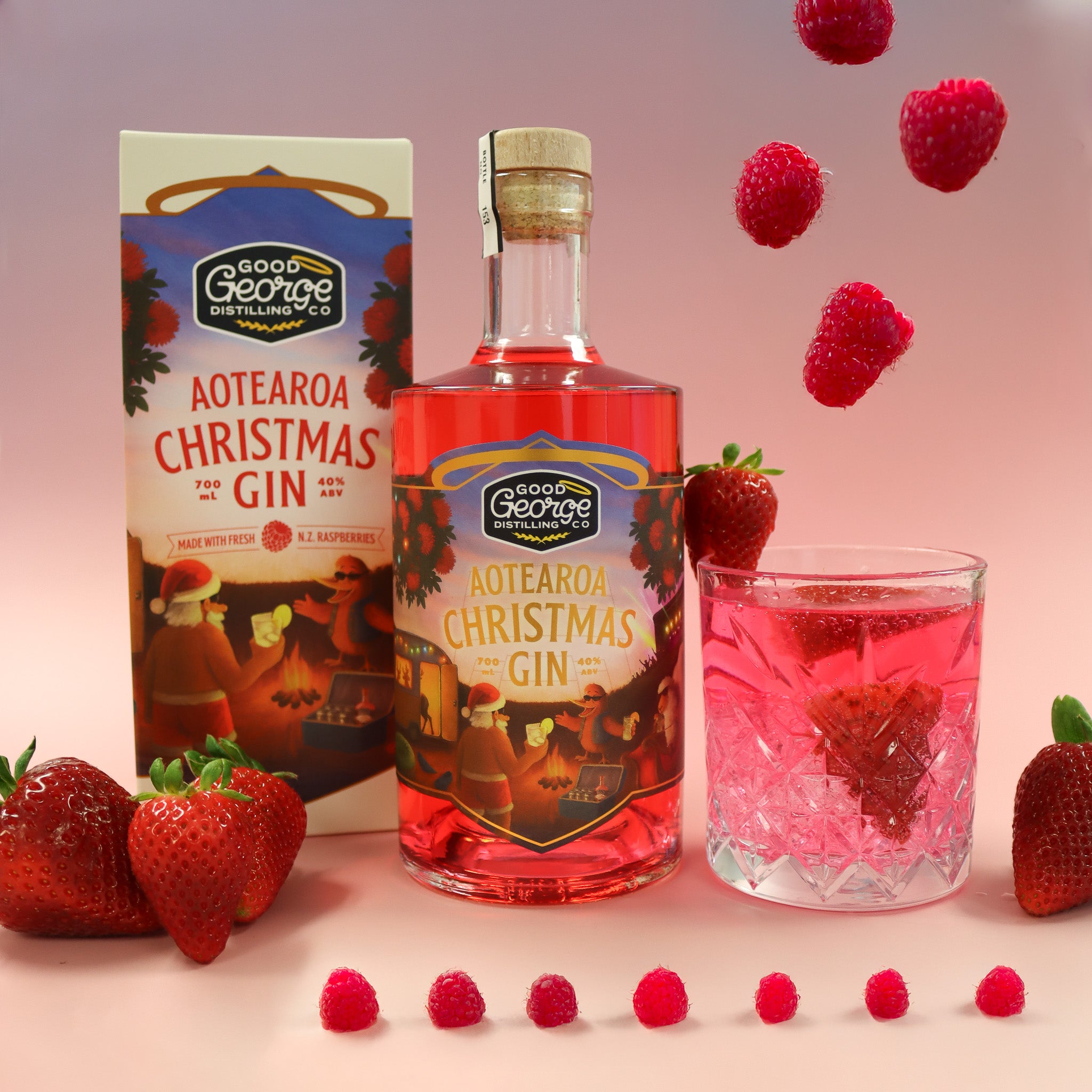 Aotearoa Christmas Gin bottle, packaging, glass with pink liquid, and strawberries on a gradient background
