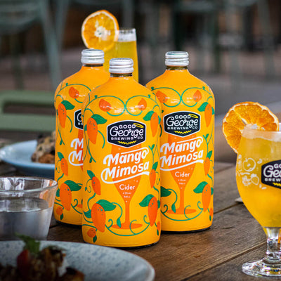 3 bottles of Mango Mimosa cider in a brunch setting