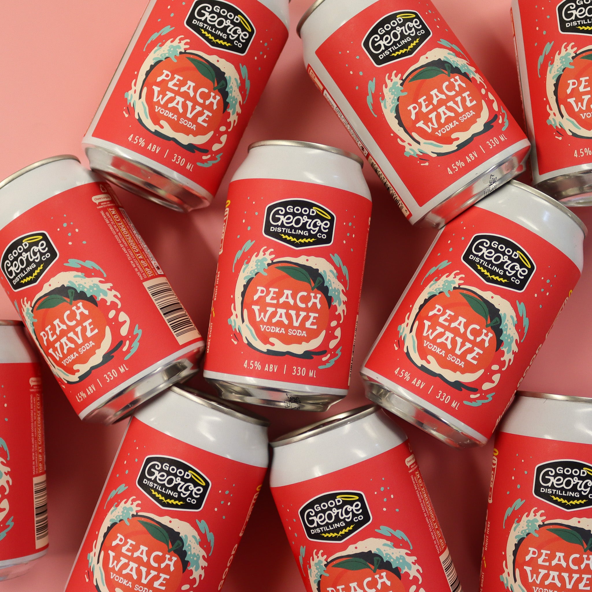 Multiple cans of Good George Peach Wave Vodka Soda on a pink background