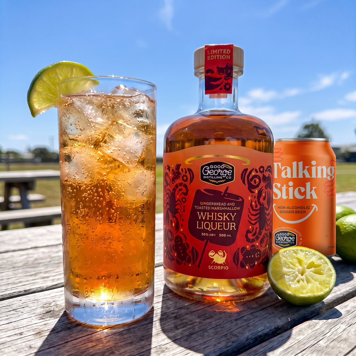 Scorpio Highball with lime beside Good George Gingerbread and Toasted Marshmallow Whisky Liqueur and a can of Talking Stick Ginger Beer, outdoors in the sun