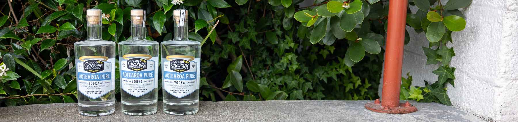 3 bottles of Aotearoa Pure Vodka bottles in a outdoor setting