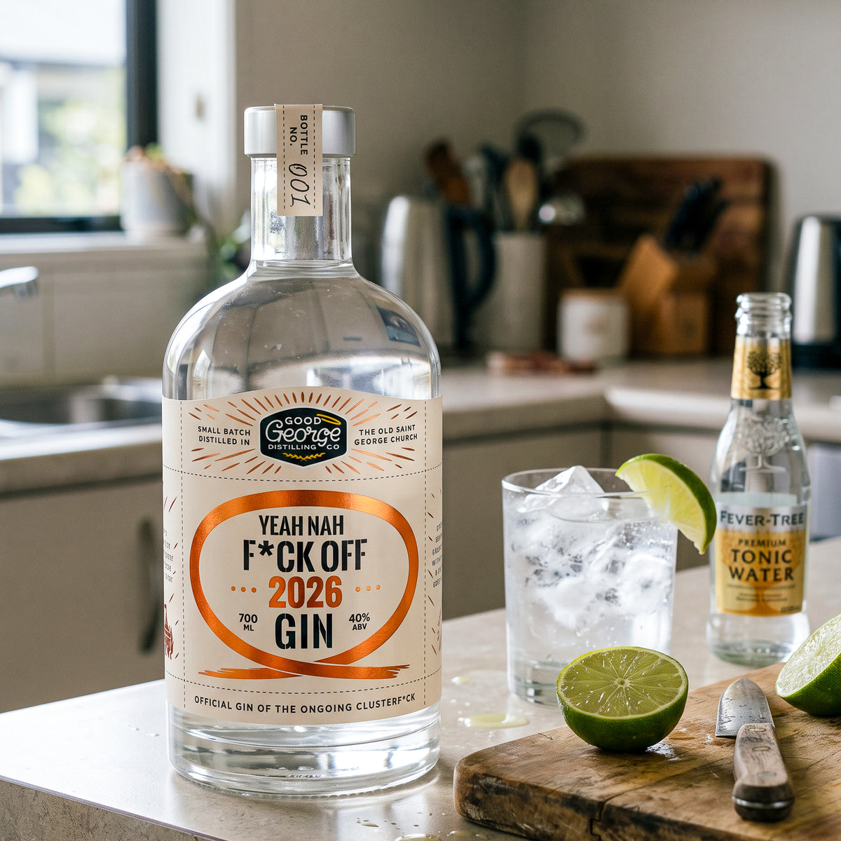 A bottle of Yeah Nah F*ck Off 2026 Gin on the kitchen bench with a gin and tonic next to it with limes cut