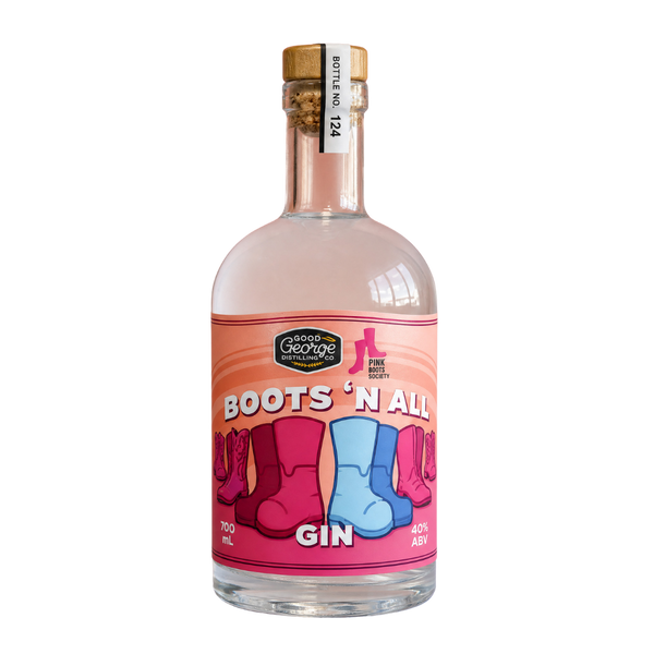 A bottle called 'Boots 'N All' Gin on a solid white background. The bottle is clear glass, showing a pale pink liquid inside, with a gold screw cap and a vibrant pink label featuring illustrations of pink, magenta, and blue cowboy boots.