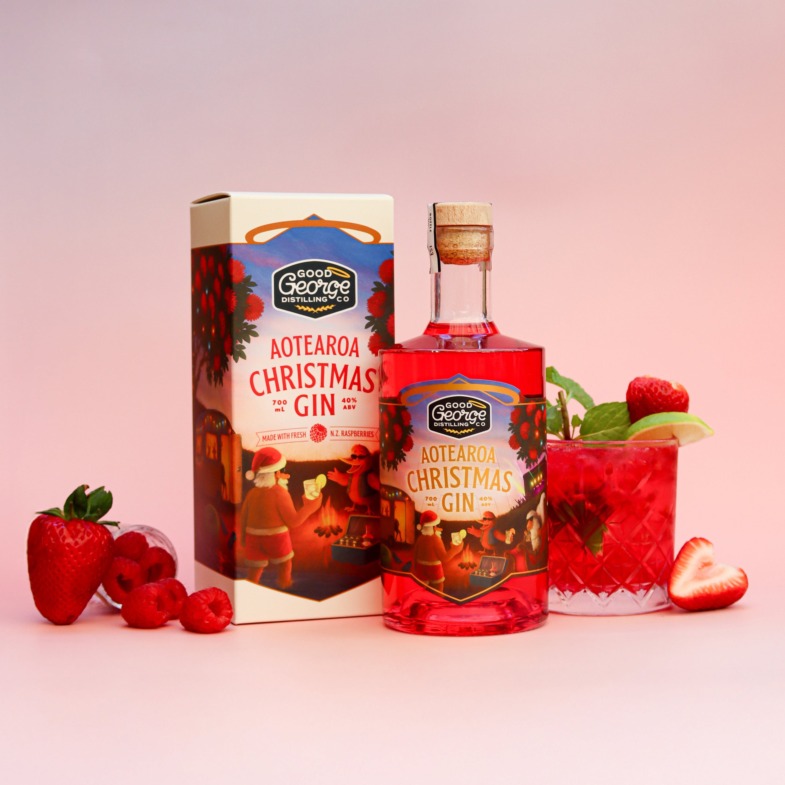 Aotearoa Christmas Gin bottle and packaging with a glass of gin and tonic on a pink background