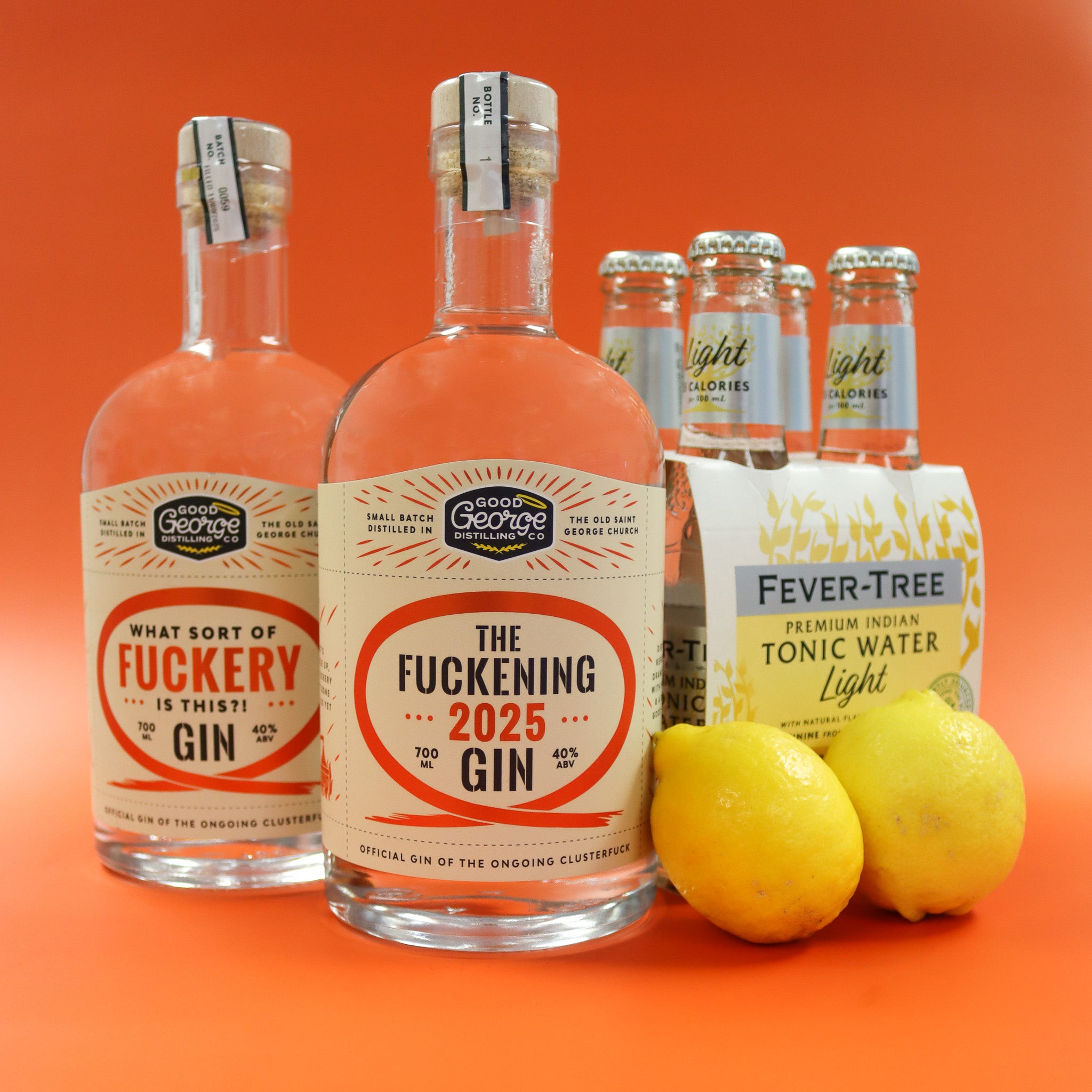 Bottles of 'The Fuckening 2025 Gin' with a box of Fever-Tree tonic water and lemons on an orange background.
