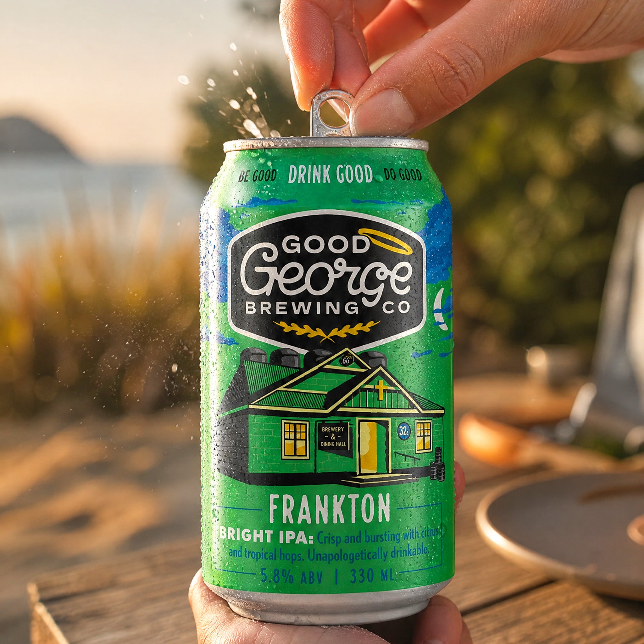 Green can of Good George Brewing Co. beer being opened outdoors.