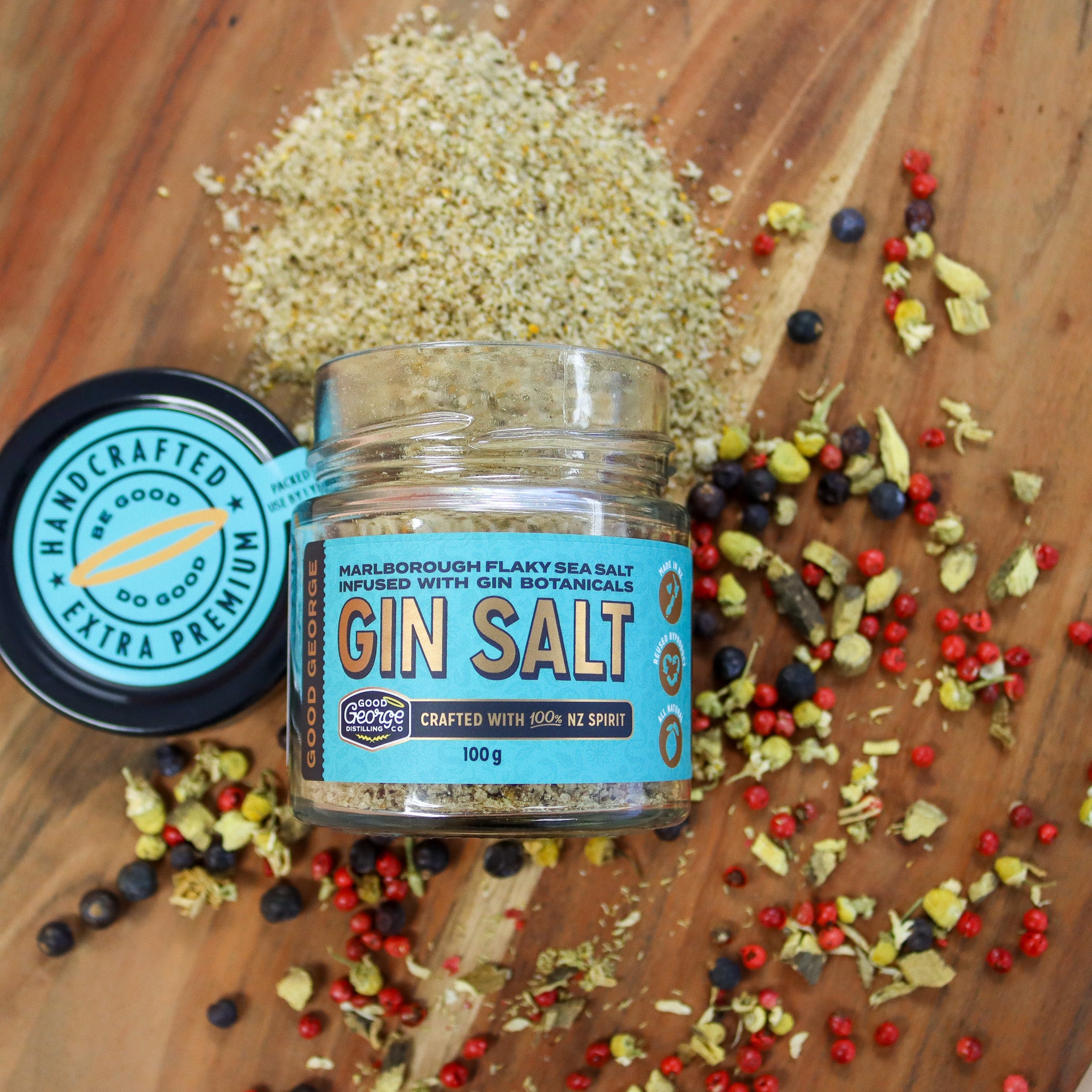 Jar of gin salt with botanicals on a wooden surface