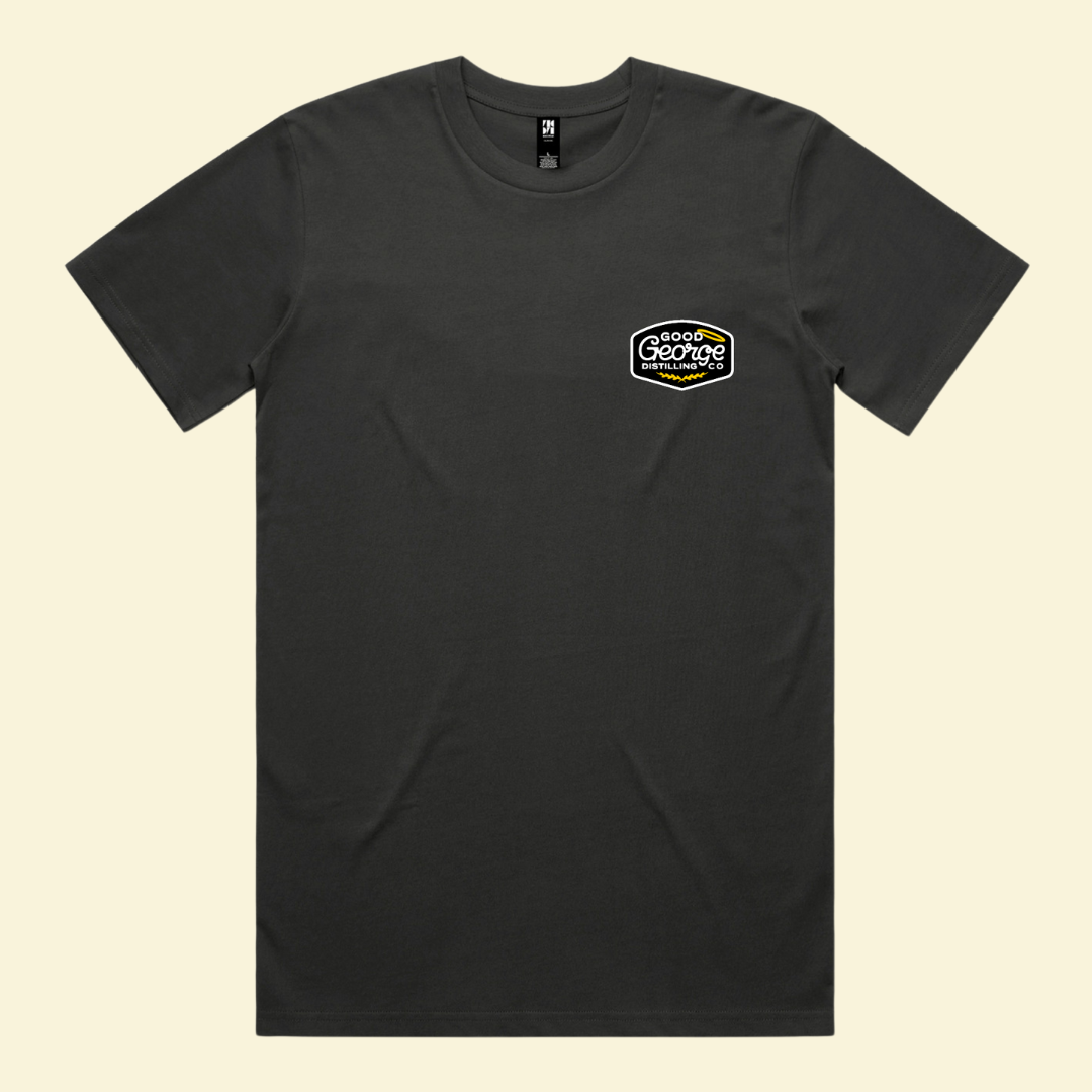 Black t-shirt with a logo on the chest against a beige background