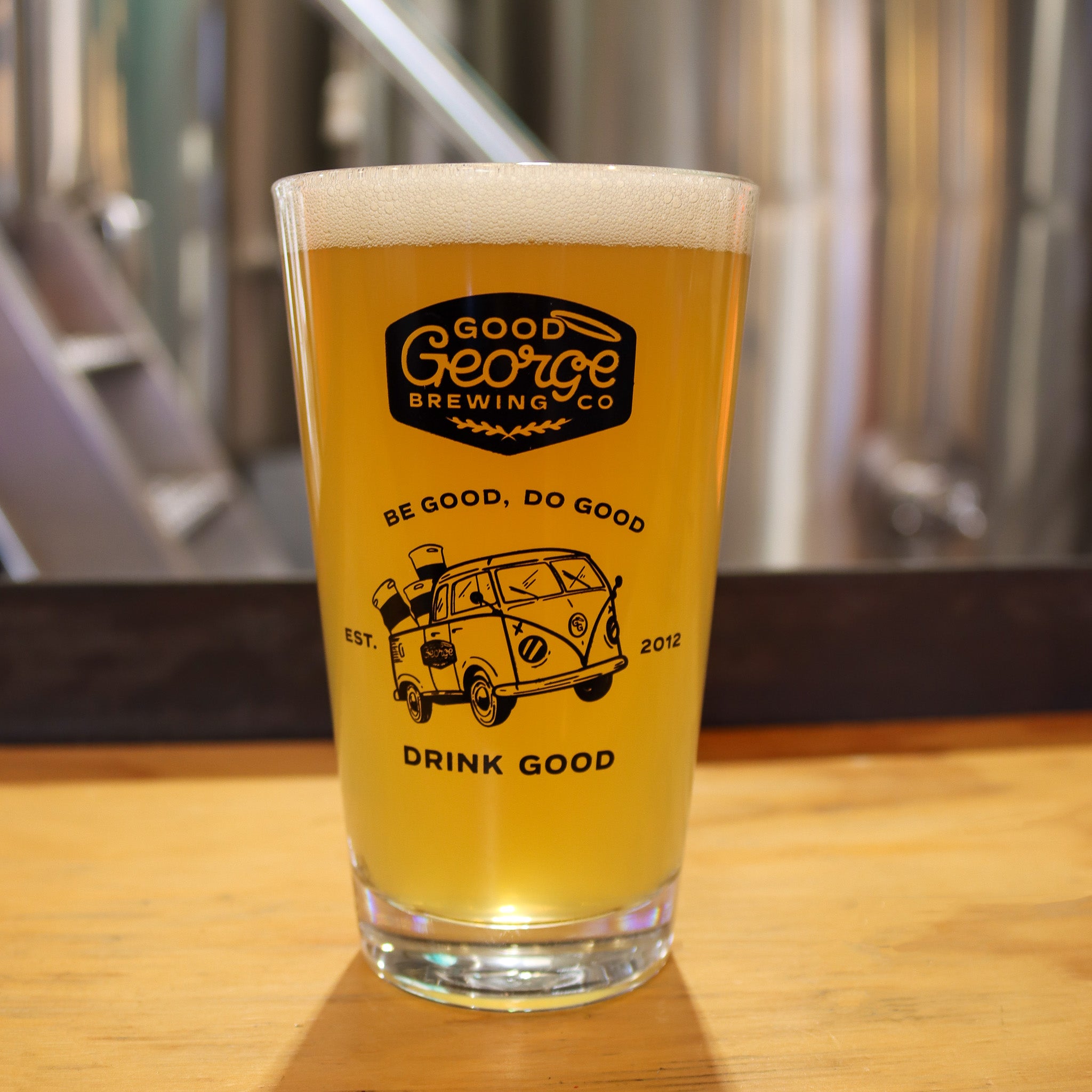 Pint of beer from Good George Brewing Co on a wooden surface with blurred background
