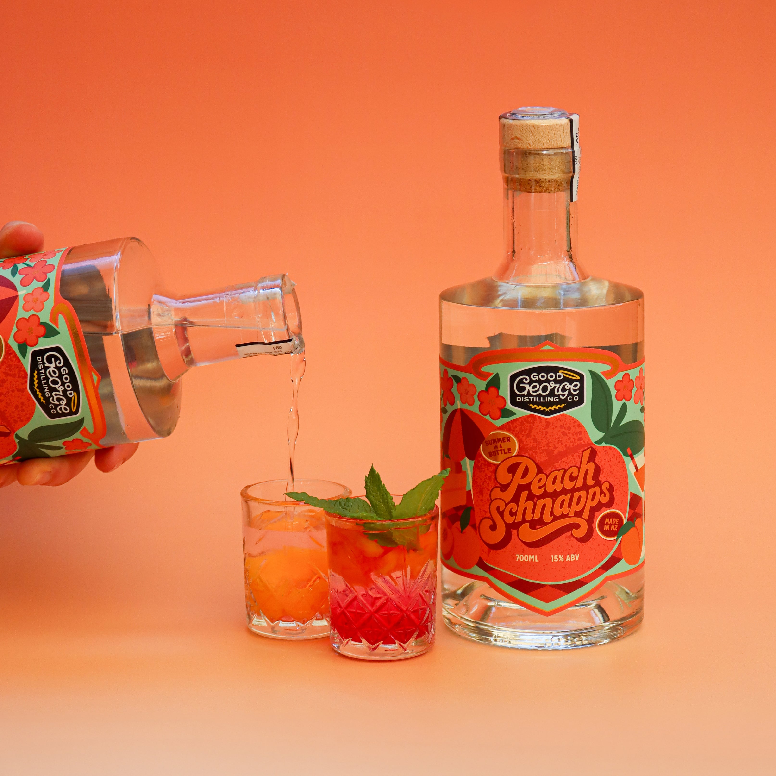 Peach Schnapps being poured into a glass with a bottle of Peach Schnapps on an orange background