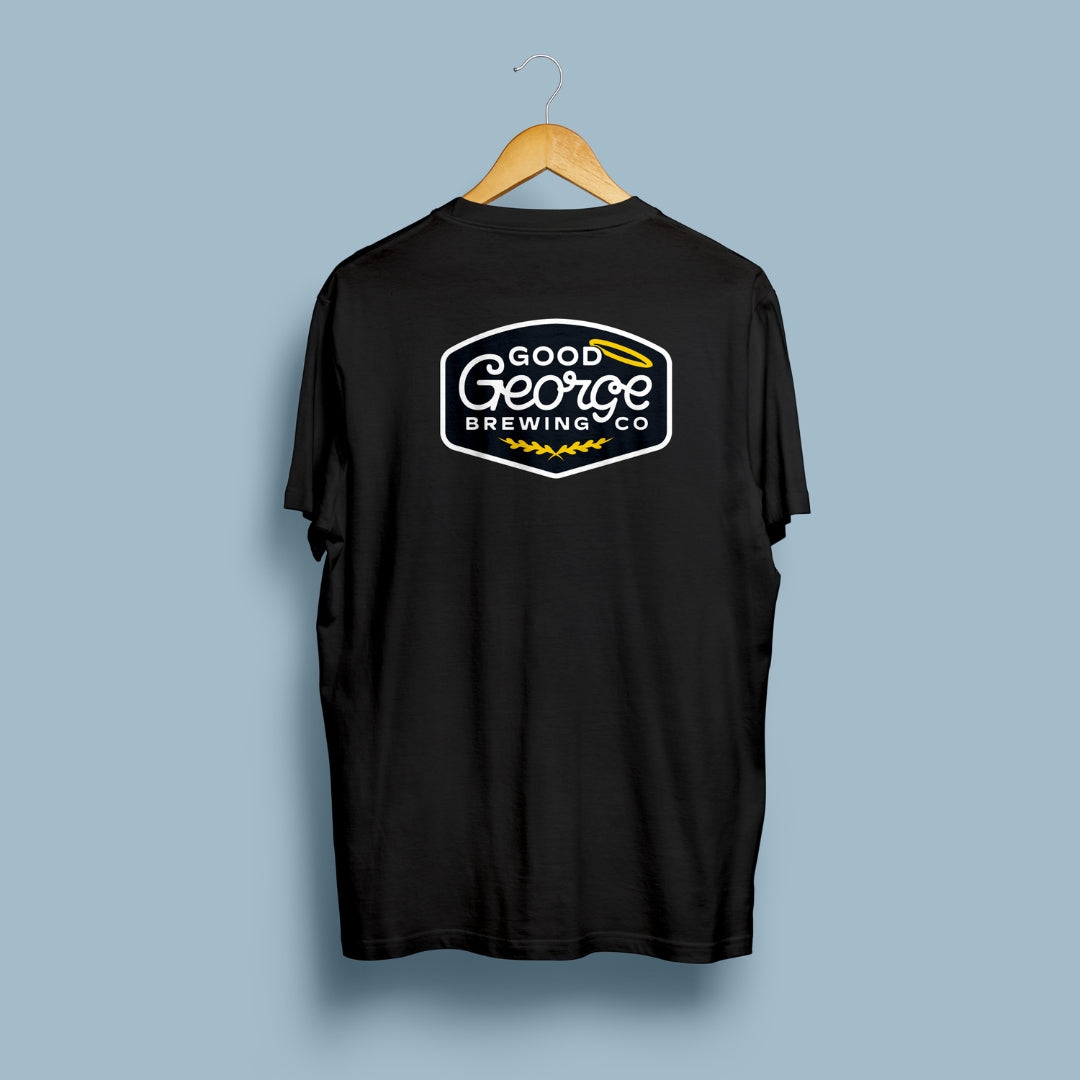 Black t-shirt with 'Good George Brewing Co' logo on a hanger against a light blue background