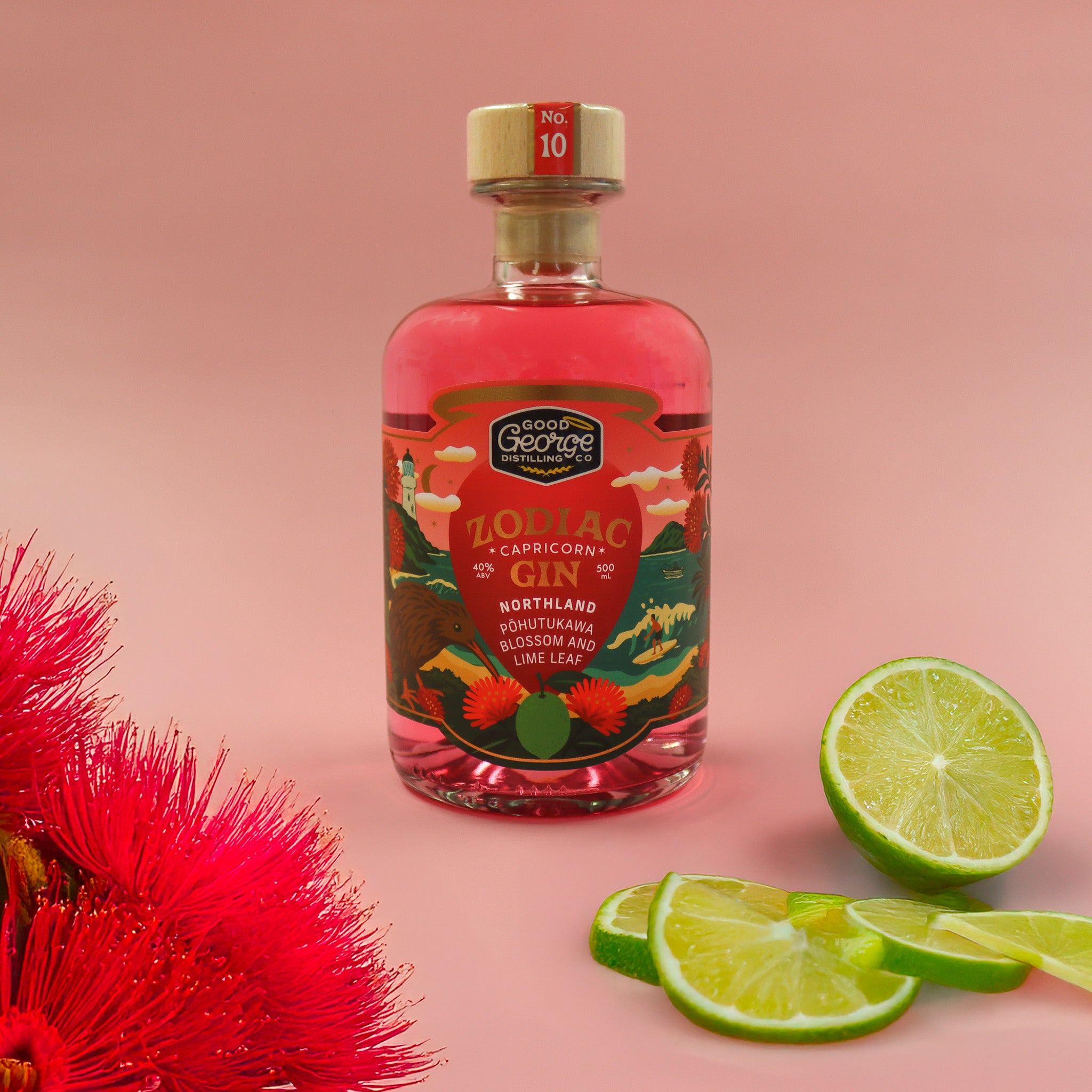 Bottle of Zodiac Gin with a pink liquid, surrounded by lime slices and a red flower on a pink background.