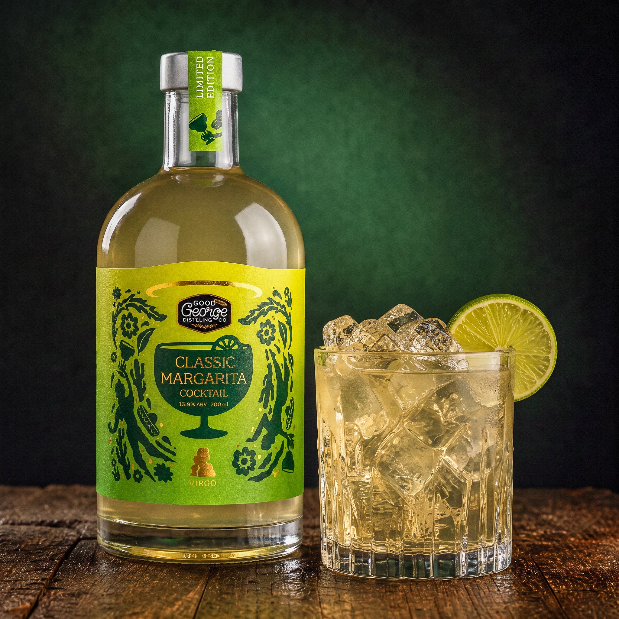 A bottle of Good George Classic Margarita cocktail liquor stands next to a rocks glass filled with ice and a lime wheel, set on a rustic wooden surface against a dark green background.